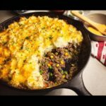 A hearty skillet supper with big flavor, featuring a savory ground meat and vegetable filling topped with mashed potatoes and melted cheese.